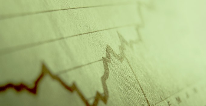 Stock chart in the newspaper, moving upwards.