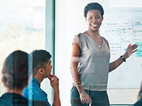 Female presenting in a meeting