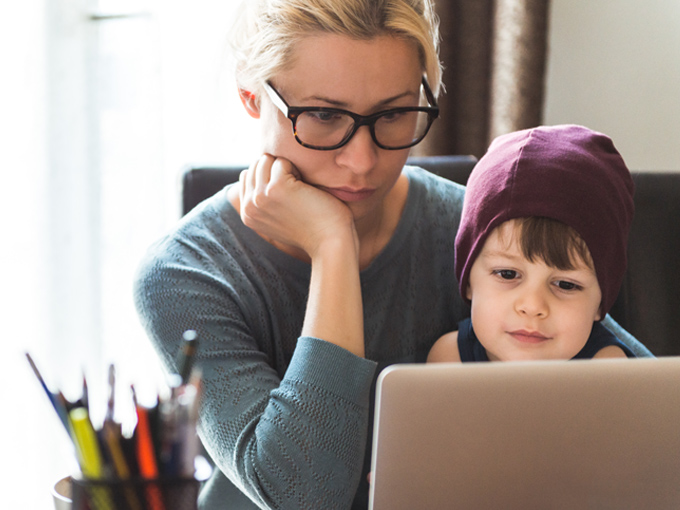 mother and son sitting using a laptop